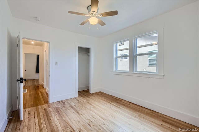 unfurnished bedroom with a closet, visible vents, light wood-style flooring, and baseboards