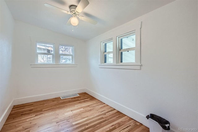 unfurnished room with a ceiling fan, baseboards, visible vents, and light wood-type flooring