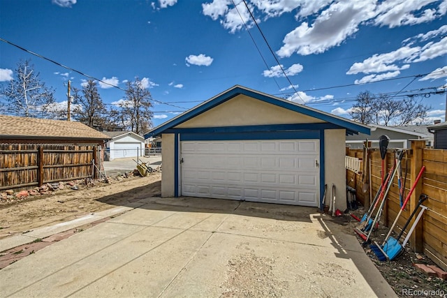 detached garage featuring fence