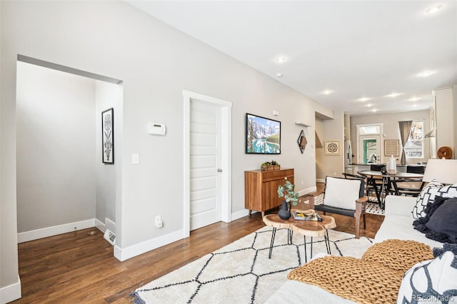 living room with dark hardwood / wood-style flooring