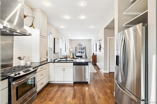 kitchen featuring sink, ventilation hood, white cabinetry, and appliances with stainless steel finishes