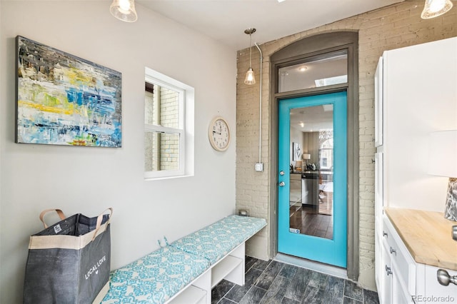 mudroom with brick wall