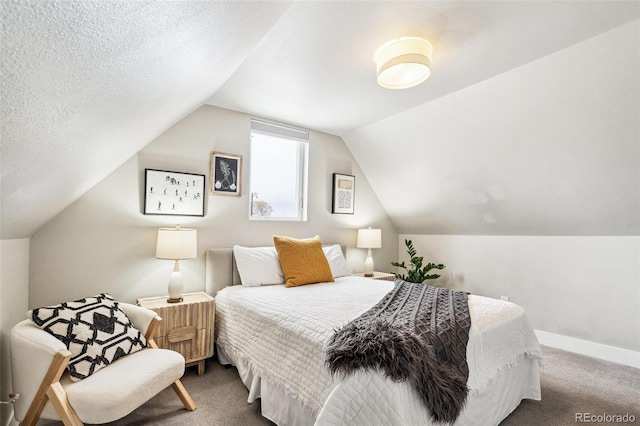 carpeted bedroom featuring a textured ceiling and lofted ceiling