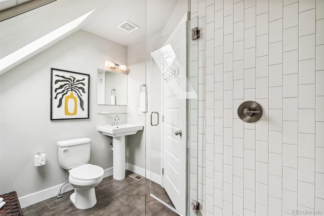 bathroom with toilet and an enclosed shower