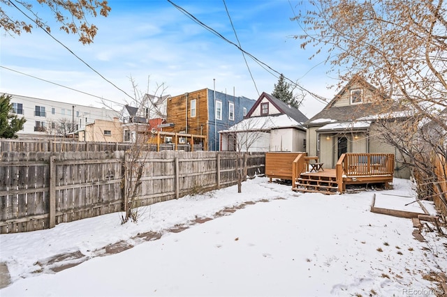 yard covered in snow featuring a wooden deck