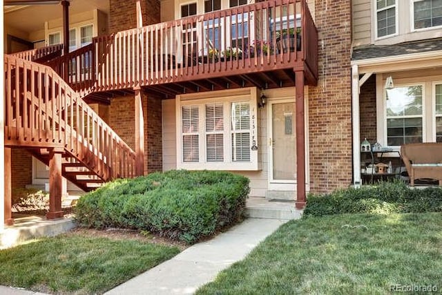 18131 E Arizona Ave Unit F, Aurora, CO 80017 - doorway to property featuring brick siding and a yard