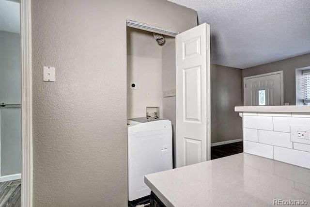 18131 E Arizona Ave Unit F, Aurora, CO 80017 - bathroom with a textured wall, wood finished floors, washer / dryer, and a textured ceiling