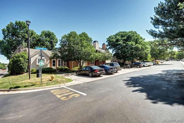 18131 E Arizona Ave Unit F, Aurora, CO 80017 - view of asphalt road with street lighting and curbs