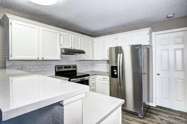 18131 E Arizona Ave Unit F, Aurora, CO 80017 - kitchen with appliances with stainless steel finishes, under cabinet range hood, wood finished floors, white cabinets, and a textured ceiling