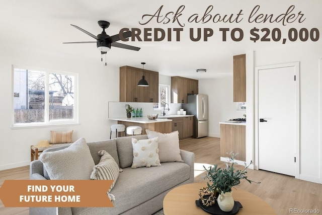 living room featuring baseboards, ceiling fan, and light wood finished floors