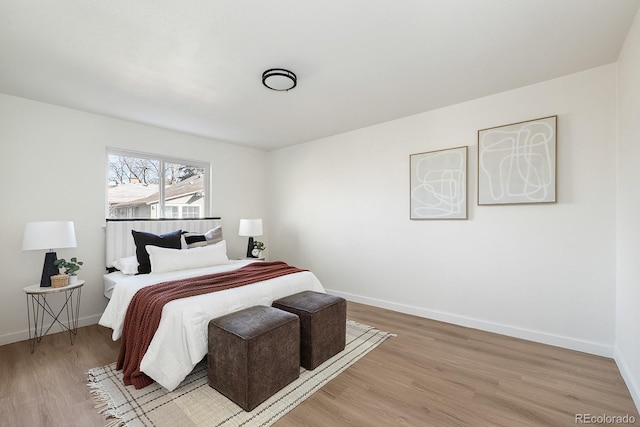 bedroom with light wood-style flooring and baseboards