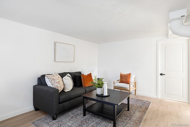 living room featuring light wood-type flooring and baseboards