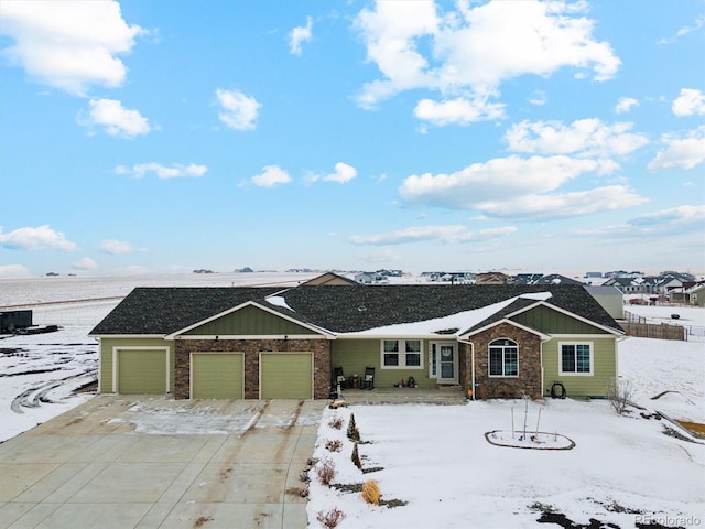 ranch-style home featuring concrete driveway, board and batten siding, and an attached garage