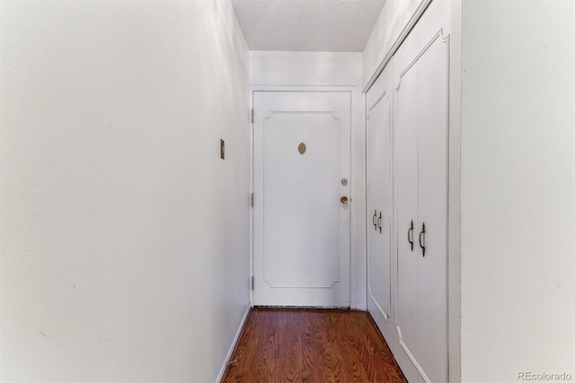 620 S Alton Way Unit 5B, Denver, CO 80247 - doorway to outside featuring wood finished floors, a textured ceiling, and baseboards