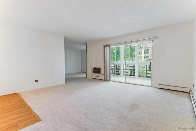 620 S Alton Way Unit 5B, Denver, CO 80247 - empty room with a baseboard radiator, carpet flooring, a baseboard heating unit, and heating unit
