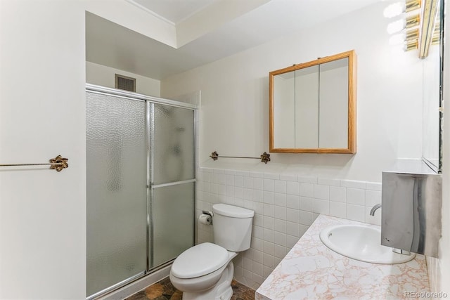 620 S Alton Way Unit 5B, Denver, CO 80247 - bathroom with tile walls, a shower stall, toilet, vanity, and a wainscoted wall