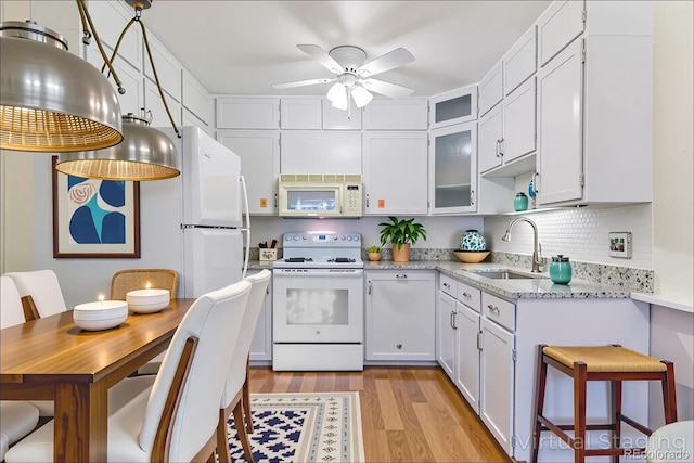 620 S Alton Way Unit 5B, Denver, CO 80247 - kitchen featuring white appliances, light wood-style flooring, ceiling fan, and white cabinetry