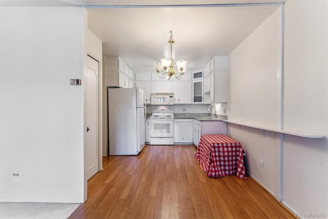 620 S Alton Way Unit 5B, Denver, CO 80247 - kitchen with white appliances, a chandelier, white cabinets, and light wood-style flooring
