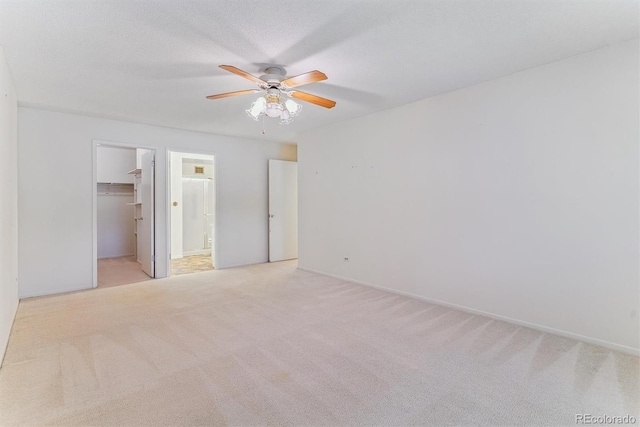 620 S Alton Way Unit 5B, Denver, CO 80247 - unfurnished bedroom featuring a spacious closet, light colored carpet, a closet, a ceiling fan, and ensuite bath
