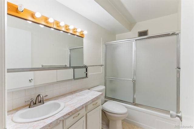 620 S Alton Way Unit 5B, Denver, CO 80247 - bathroom featuring vanity, decorative backsplash, and combined bath / shower with glass door