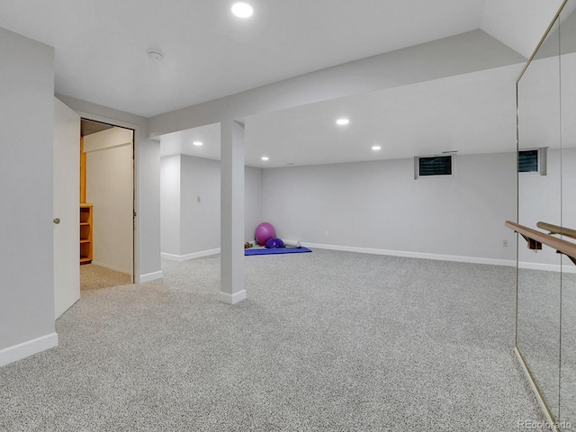 finished basement featuring light carpet, recessed lighting, and baseboards