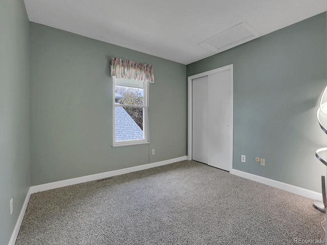 unfurnished bedroom with carpet flooring, baseboards, and a closet