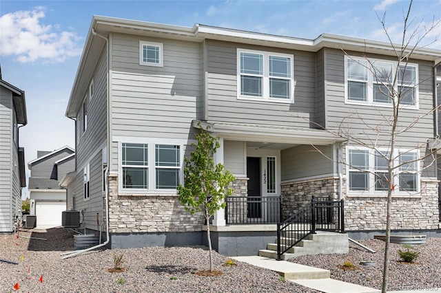 view of front of home with stone siding and central air condition unit