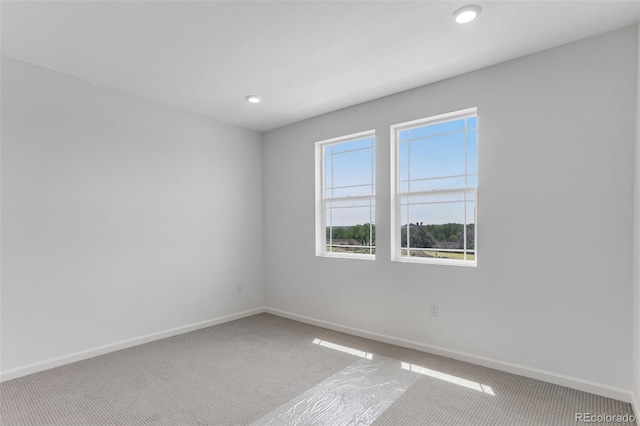 carpeted spare room with baseboards and recessed lighting