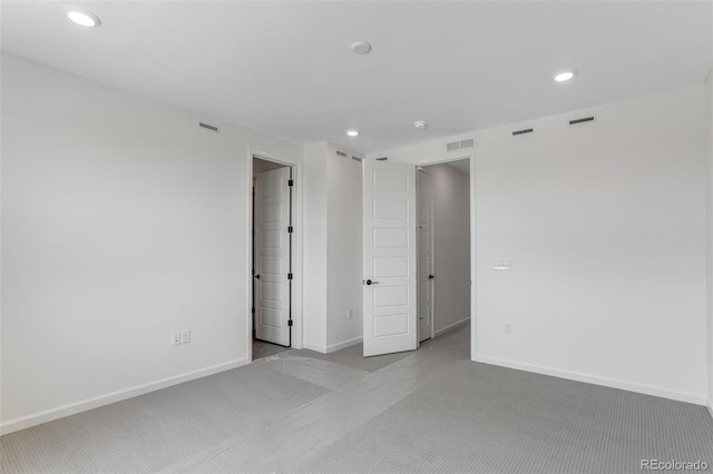 unfurnished bedroom featuring carpet, baseboards, and recessed lighting
