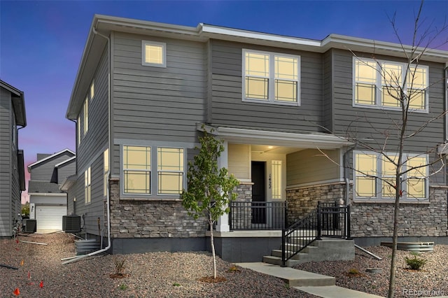 view of front of home with stone siding and cooling unit
