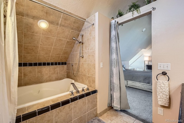 1065 6th St, Berthoud, CO 80513 - ensuite bathroom with tiled shower / bath combo, tile patterned floors, and lofted ceiling
