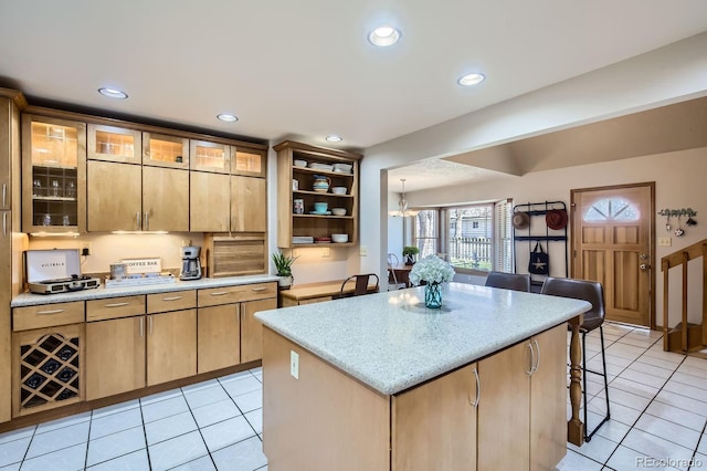 1065 6th St, Berthoud, CO 80513 - kitchen featuring light tile patterned floors, open shelves, a kitchen island, recessed lighting, and a breakfast bar area