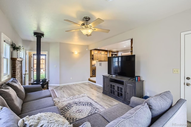 1065 6th St, Berthoud, CO 80513 - living room featuring ceiling fan, light wood-style floors, and baseboards