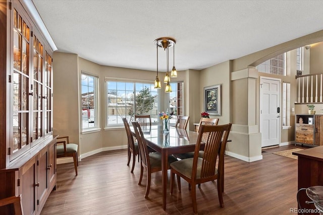 dining room featuring dark hardwood / wood-style floors and a textured ceiling