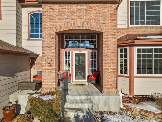 view of snow covered property entrance