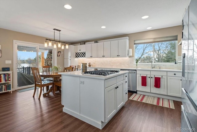 kitchen featuring white cabinetry, appliances with stainless steel finishes, and pendant lighting