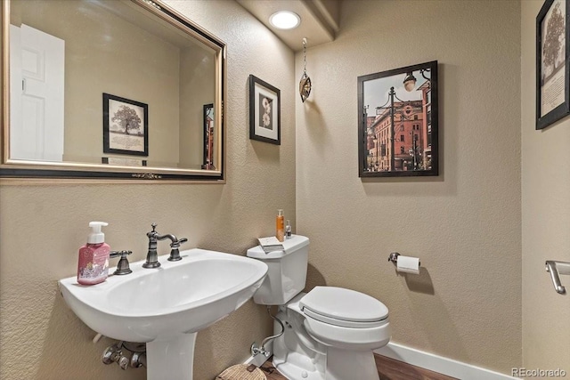 bathroom featuring sink and toilet