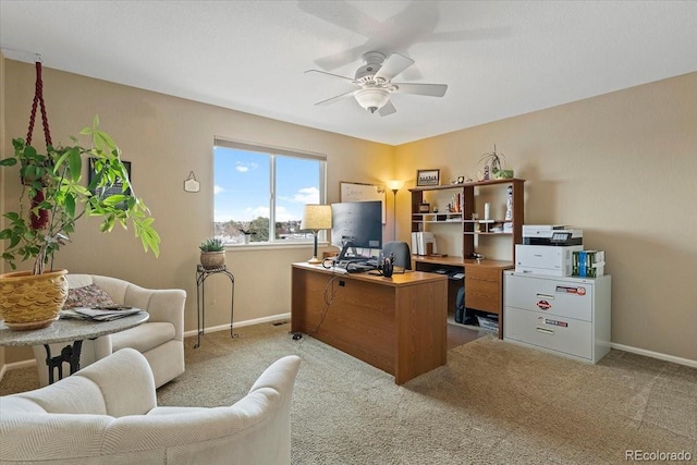 home office with light carpet and ceiling fan