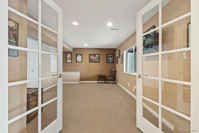 interior space with carpet flooring and french doors