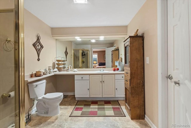 bathroom featuring vanity, an enclosed shower, and toilet