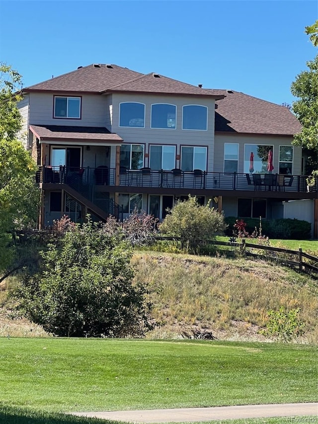 rear view of property with a lawn