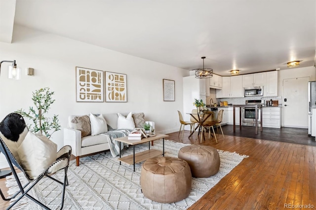 living room featuring light hardwood / wood-style flooring and sink