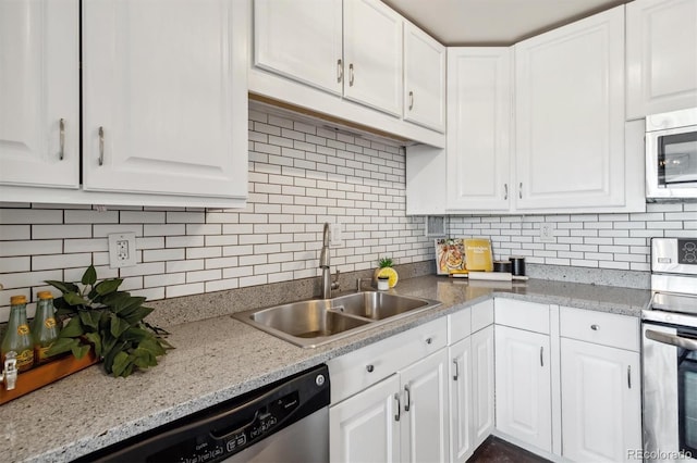 kitchen with appliances with stainless steel finishes, sink, and white cabinets