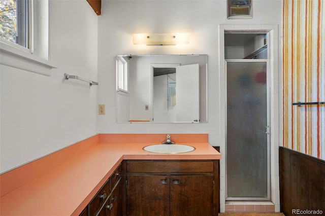 bathroom featuring vanity, walk in shower, and plenty of natural light