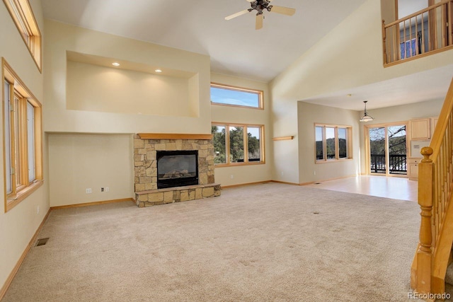 unfurnished living room featuring carpet, visible vents, and high vaulted ceiling