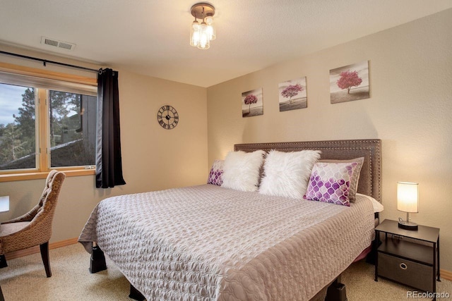 bedroom with visible vents, baseboards, and carpet