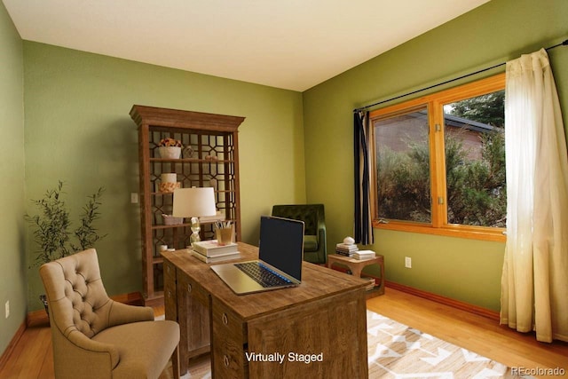 home office with baseboards and light wood-style flooring