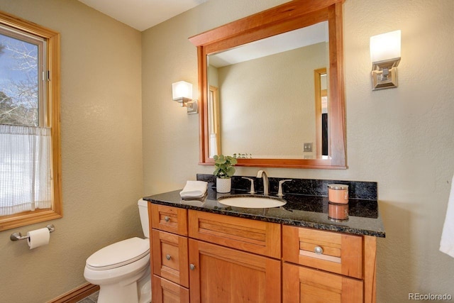 bathroom featuring toilet and vanity