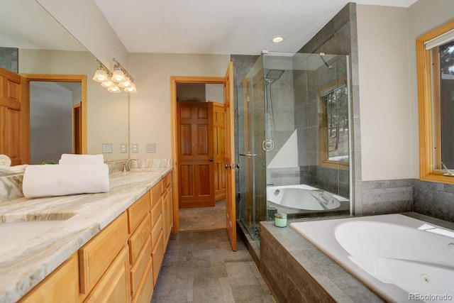 full bathroom featuring double vanity, a garden tub, a stall shower, and a sink