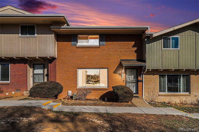 townhome / multi-family property with brick siding